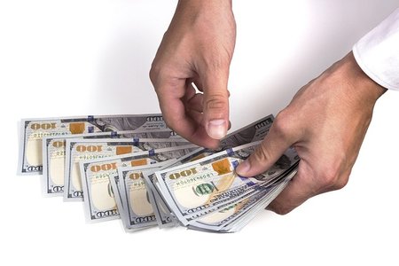 bigstock-Man-Hands-Counting-Dollar-small.jpg